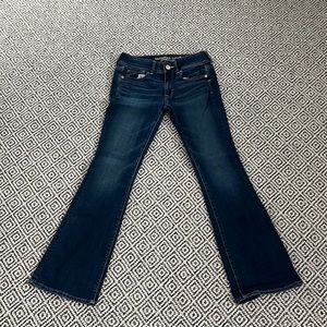 selling American Eagle super stretch kick boot jeans for 24 dollars.
